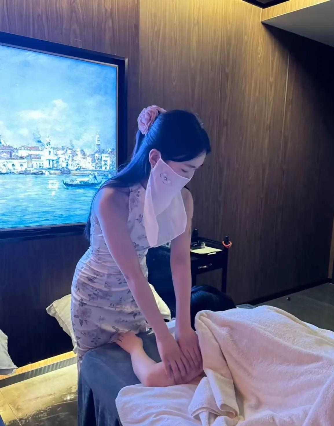 Female therapist providing a shoulder massage in a private treatment room